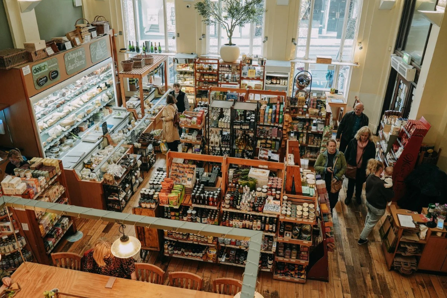 Shoppers and shelves of food and drink inside Delilah Fine Foods in Nottingham